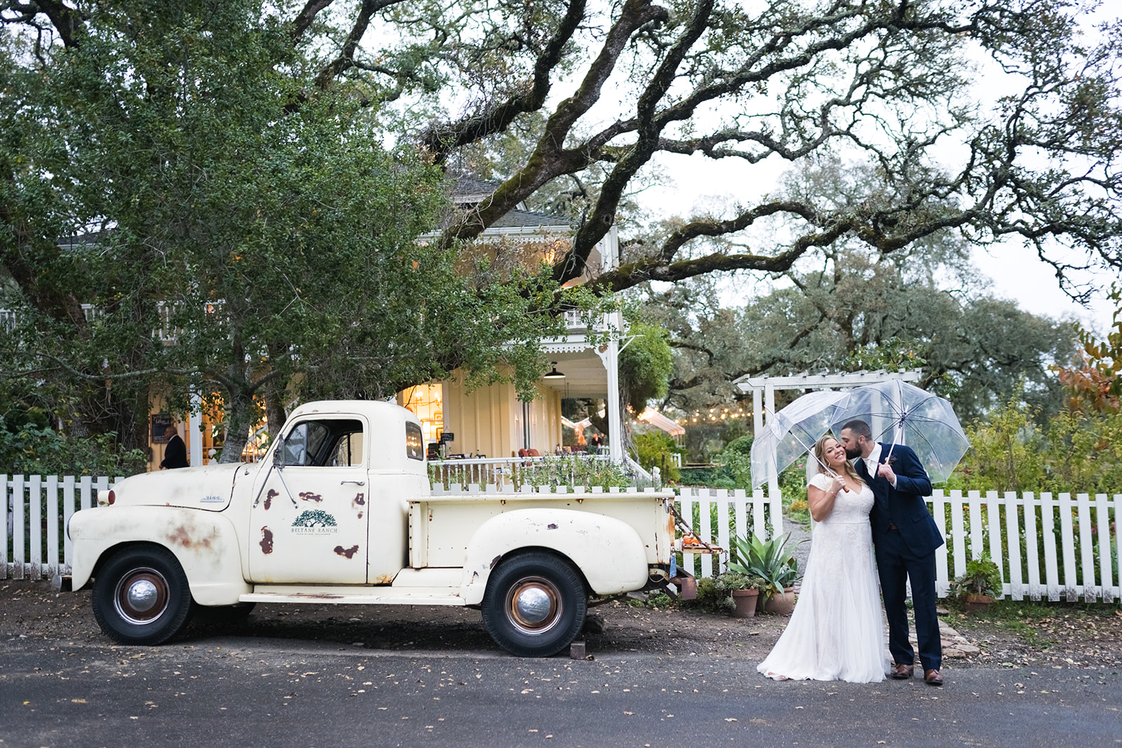 Couple kissing by vintage truck at California wedding